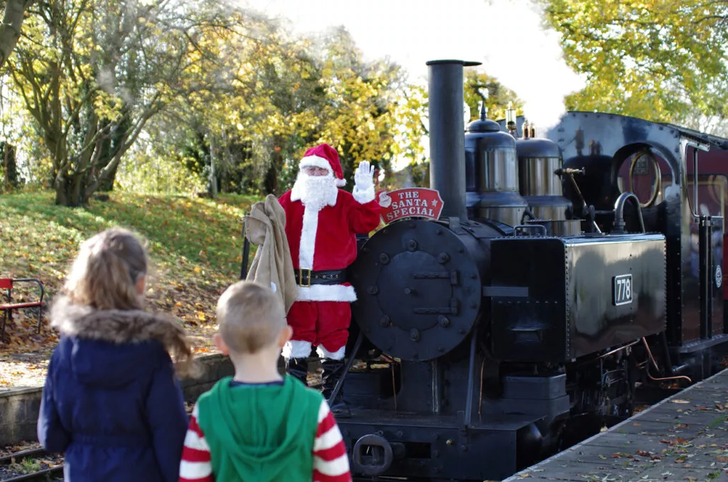 Leignton Buzzard Steam Engine with Santa standing on the front of the train.